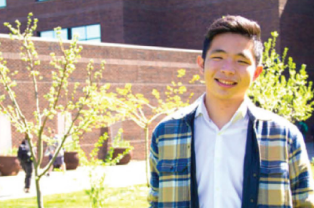 Smiling young man in blue plaid jacket